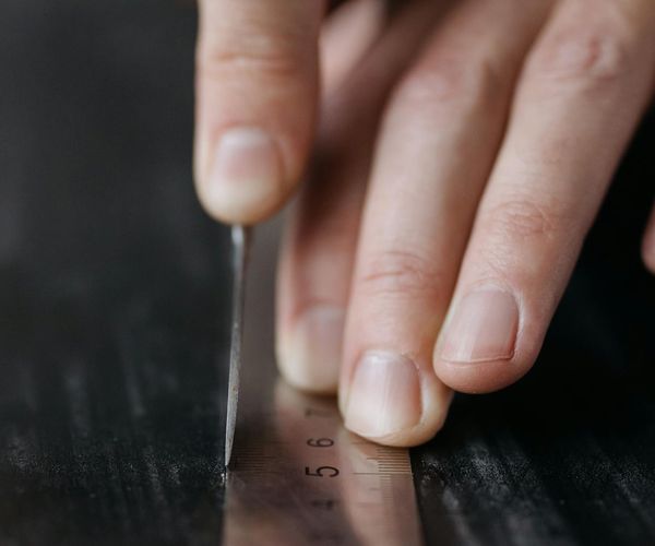 Close-up of a man's hands in a precise, controlled position.